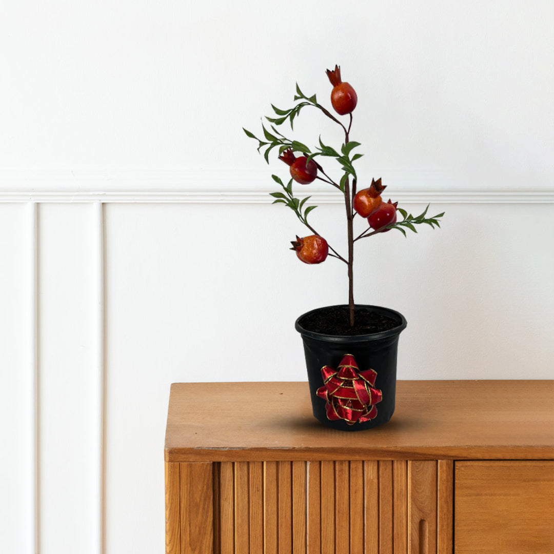 Artificial pomegranate tree bonsai with green leaves and red fruits