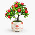 Artificial mini apple bonsai in a smiling pig-shaped ceramic planter.