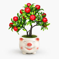 Artificial mini apple bonsai in a smiling pig-shaped ceramic planter.