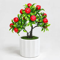 Artificial mini apple bonsai in a white ceramic planter.